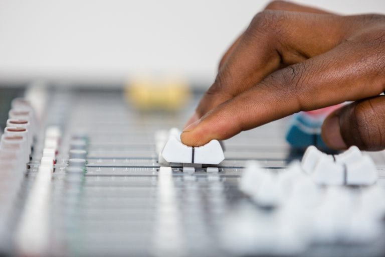 Audio visual sound mixer hands control buttons adjsuting Kenya East Africa