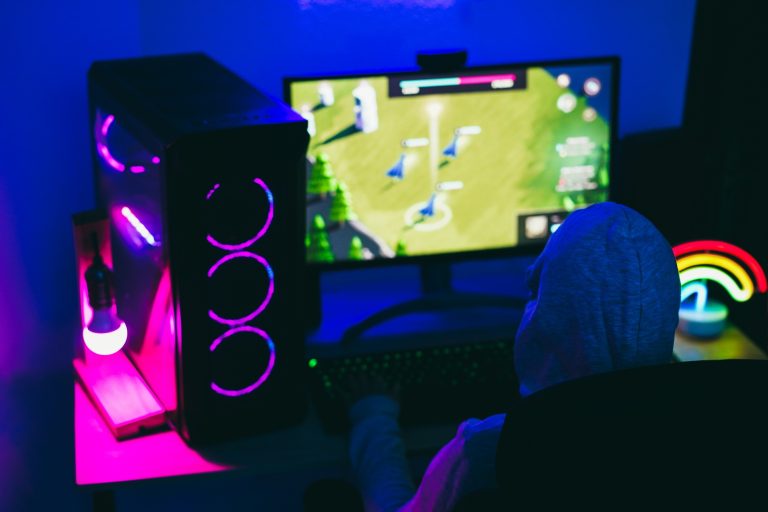 Gamer playing at strategy game while streaming online - Focus on head